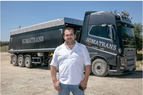 Francisco García standing in front of a Logística Somatrans truck